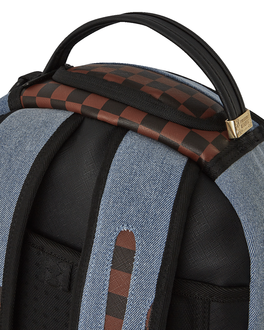 Close-up of faux leather backpack with gold zippers and shark artwork