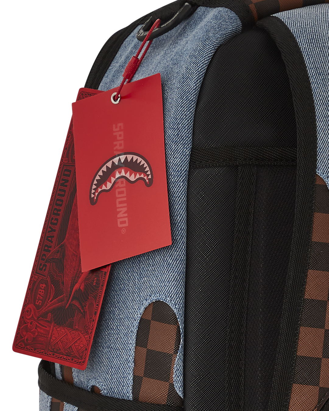 Close-up of faux leather backpack with gold zippers and shark artwork