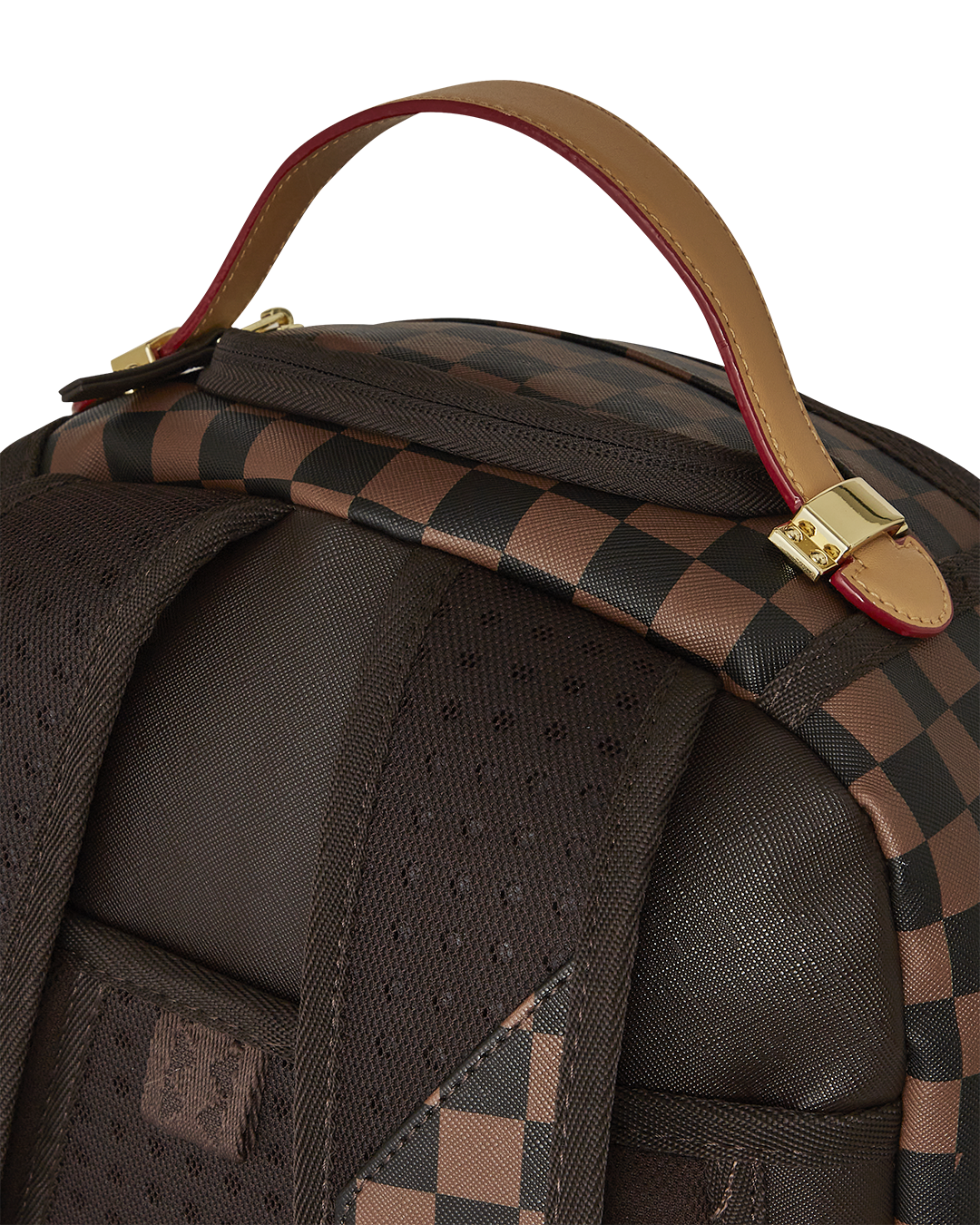 Black faux leather backpack displayed on a wooden desk with laptop inside