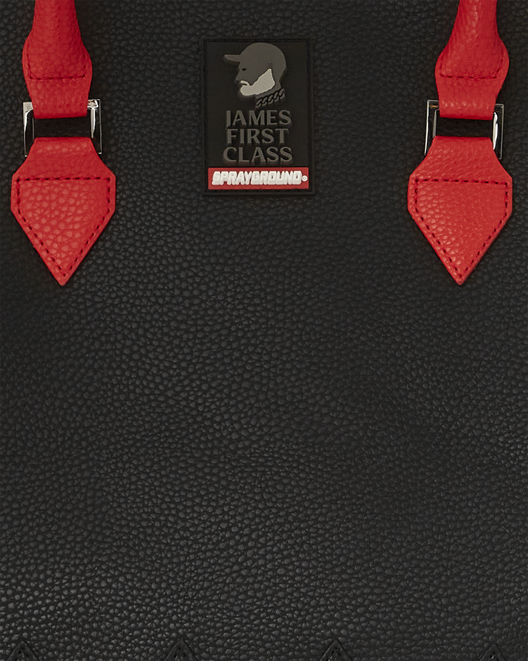 Black designer tote bag with snap closure and enamel details