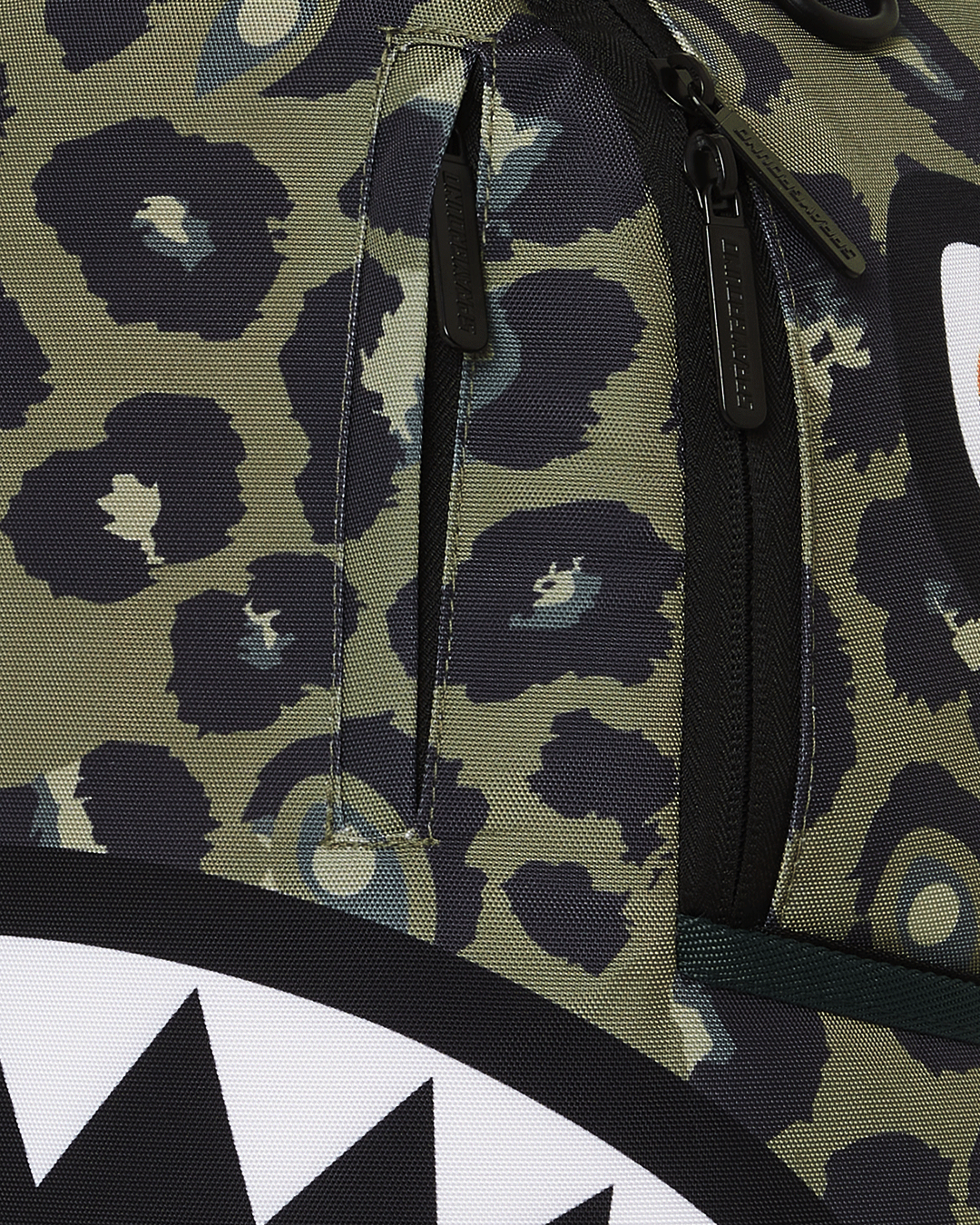 Front view of backpack showing gold zippers and padded straps