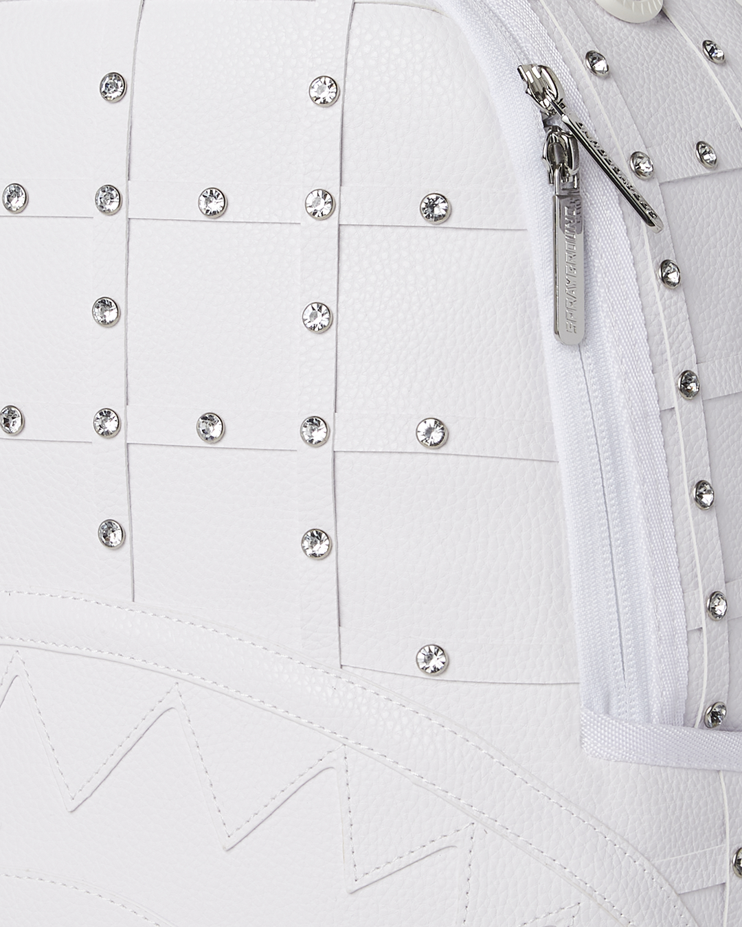 Side view of the backpack with adjustable straps and gold zipper details.