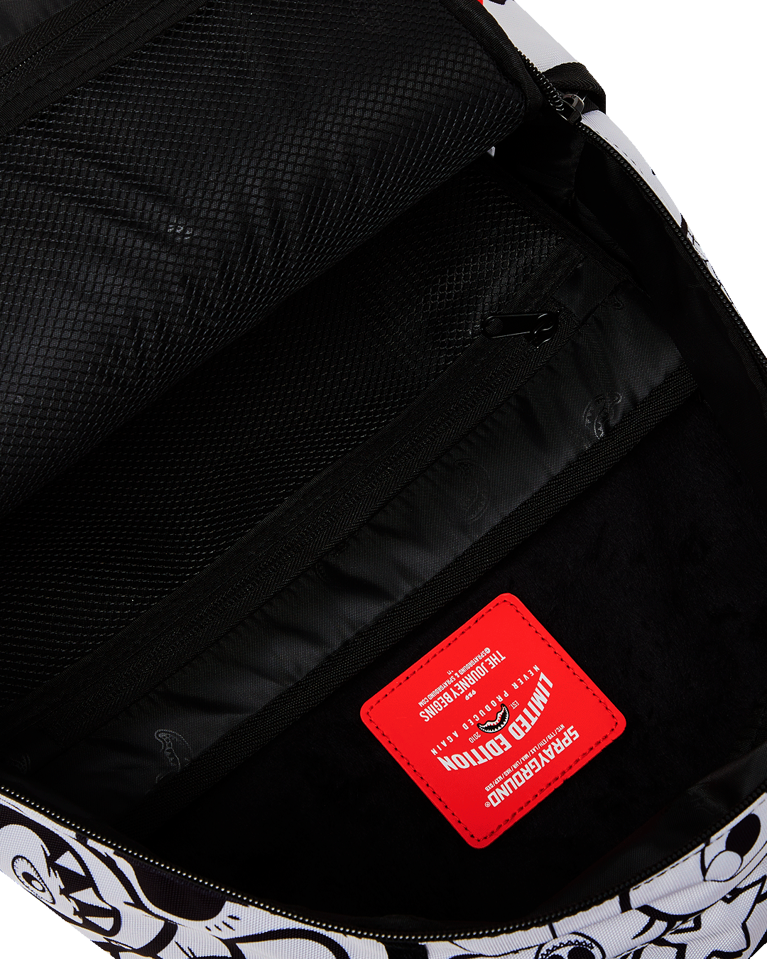 Stylish exterior of the Dreamy Doodle Deluxe Backpack with gold zippers and side pockets.