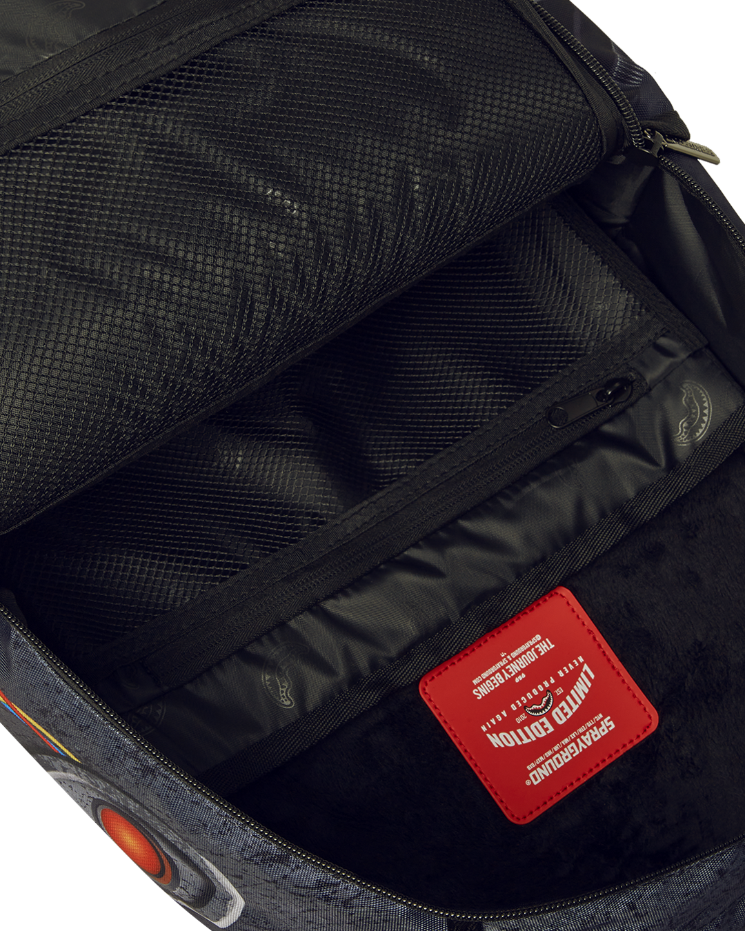 Front view of the Ghostbusters backpack with gold zipper detailing