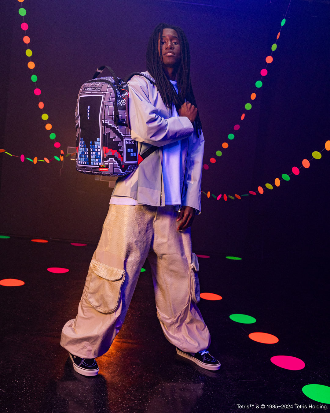 Front view of the pink sprayground backpack with Tetris shark design and gold zippers