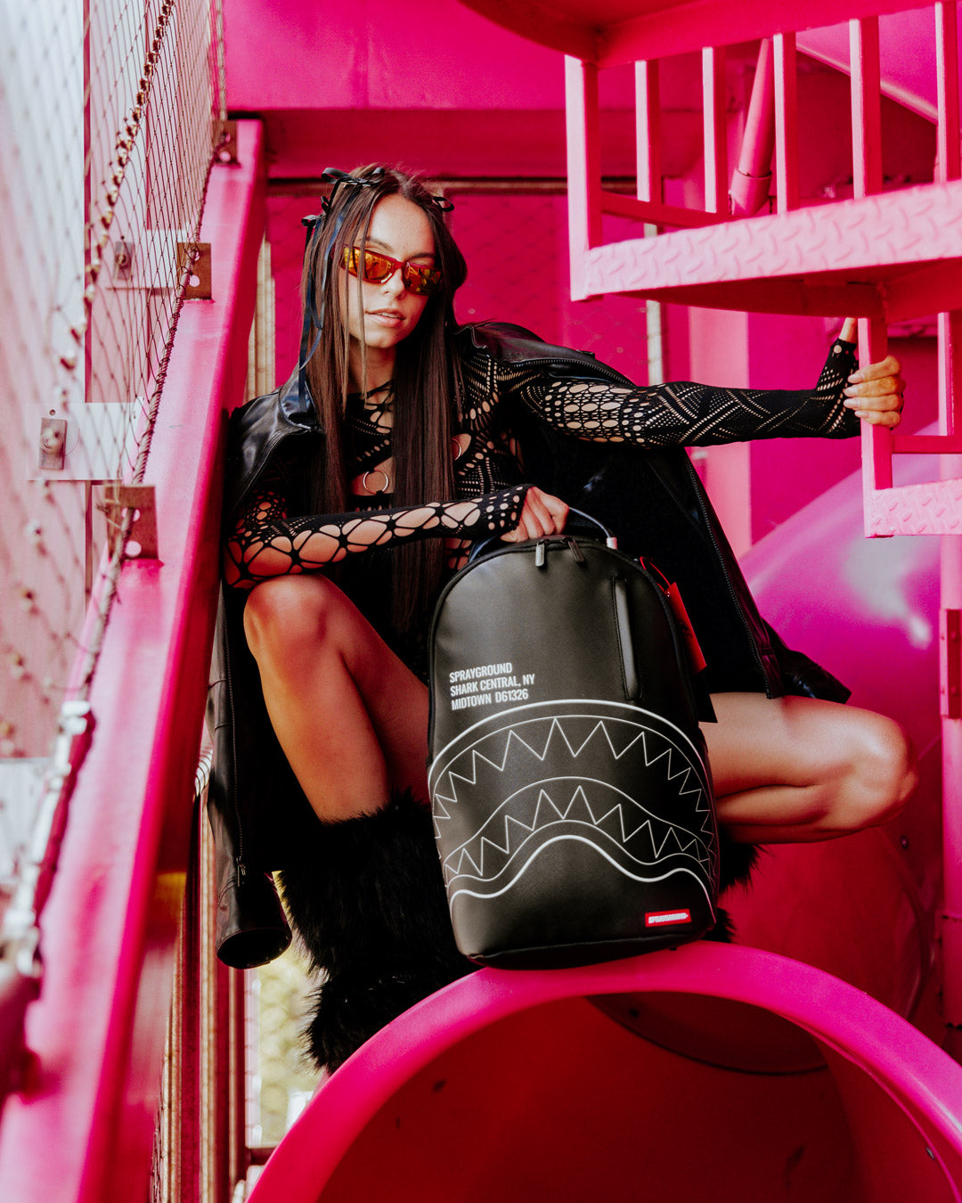 Shark Central faux leather backpack worn by a woman in a city setting
