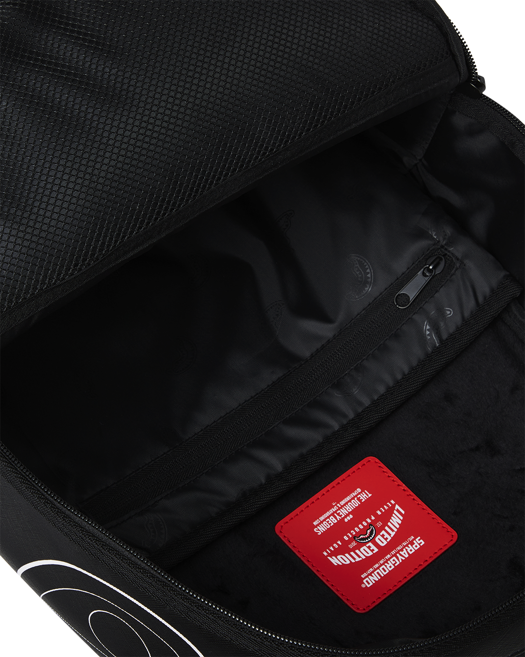 Close-up of the backpacks front zipper pockets and gold hardware