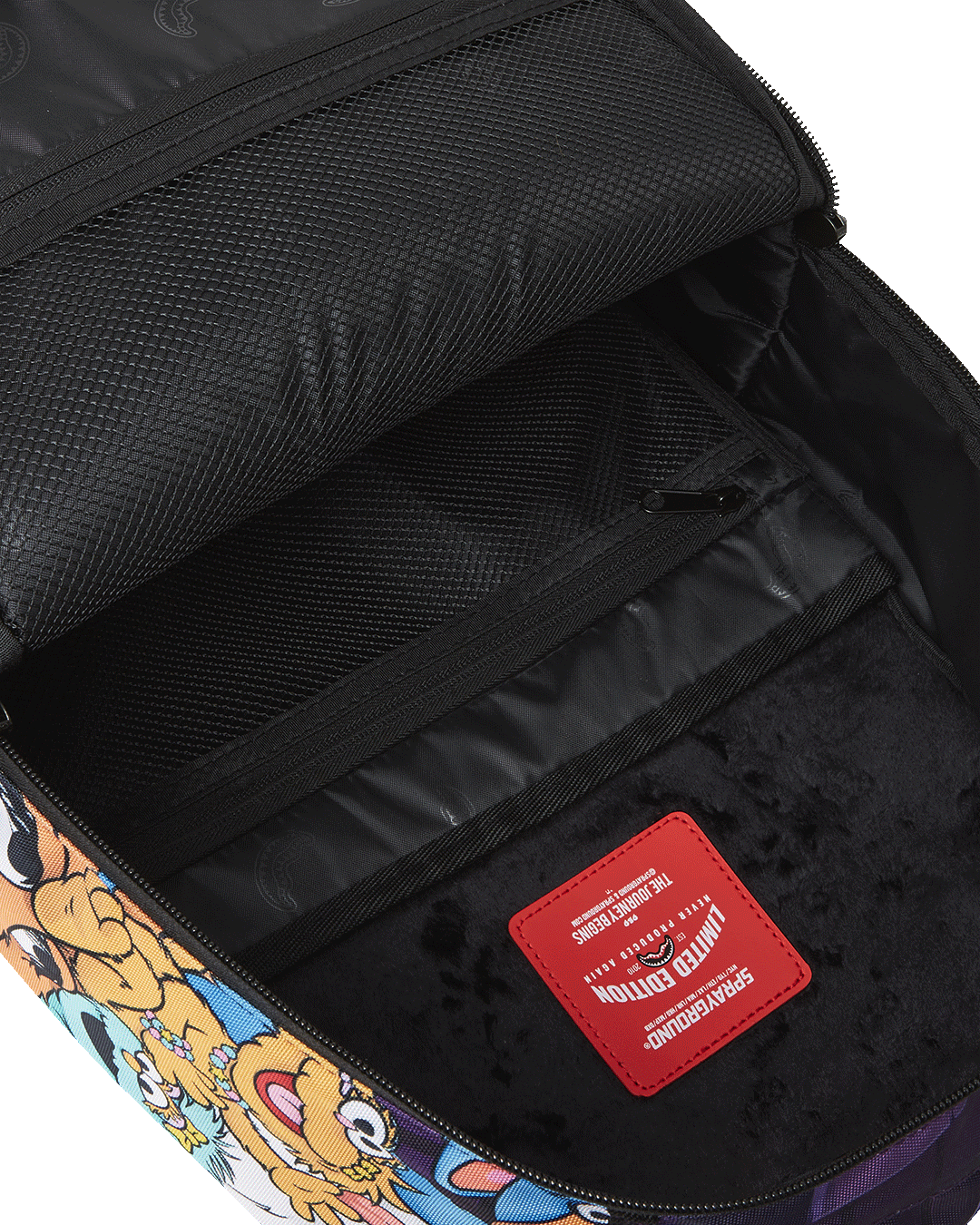 Open compartment showcasing velour laptop sleeve and organizer pockets