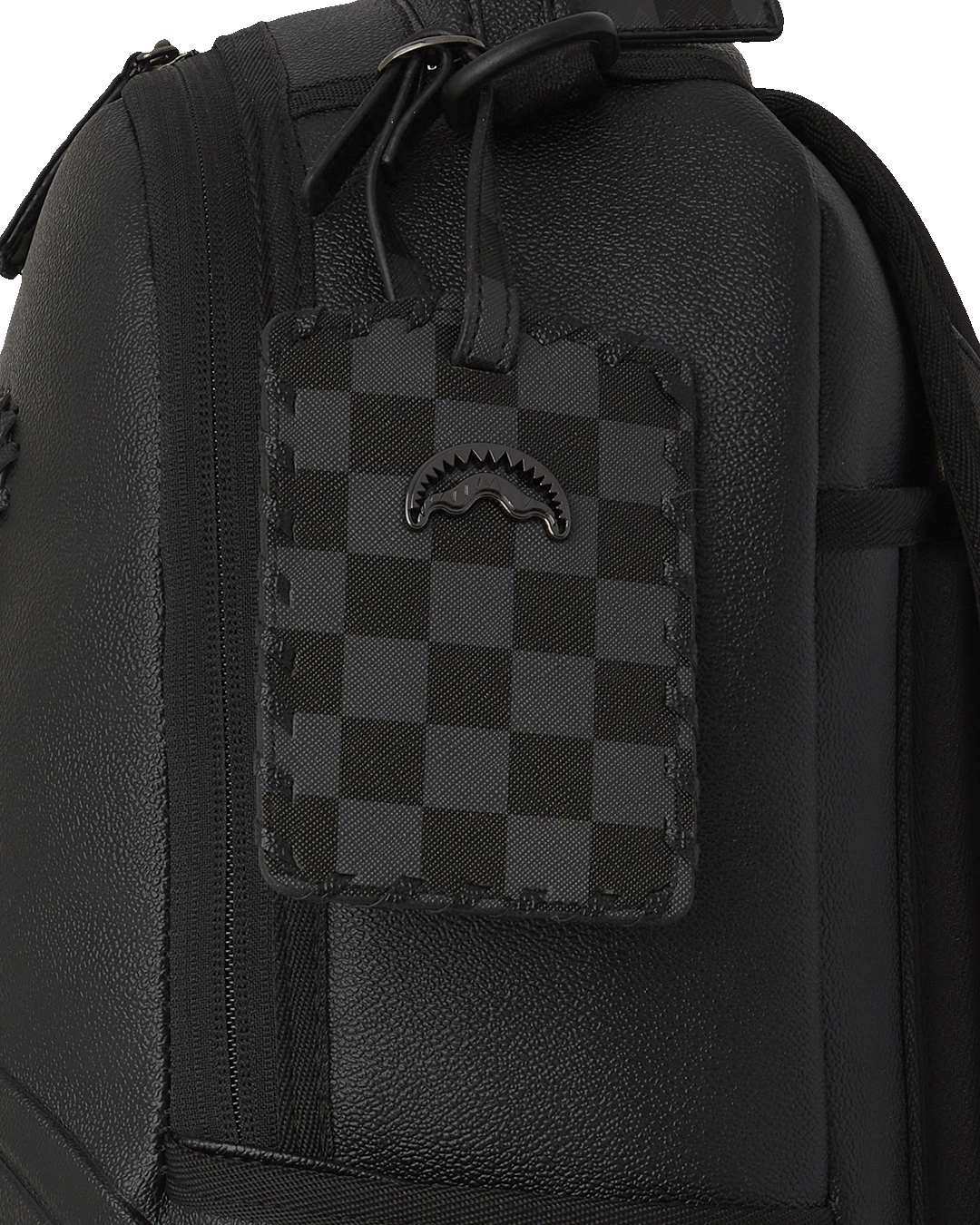 Close-up of embossed sharkmouth and gold zippers with metal hardware
