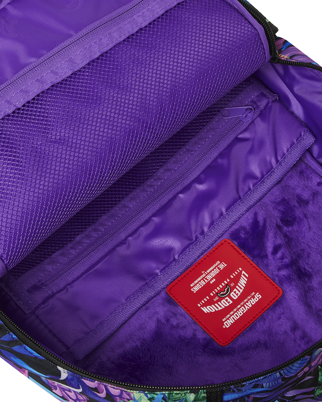Tropical Night Deluxe Laptop Backpack attached to carry-on luggage.