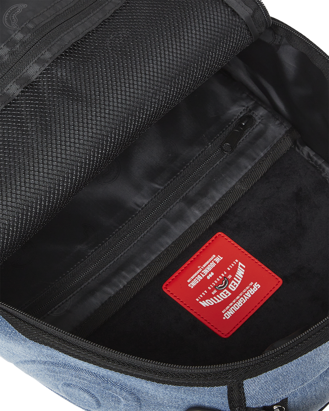 Interior view of the shark backpack showing the laptop compartment and pockets