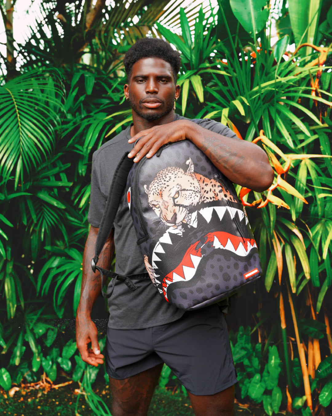 Close-up of the faux leather texture and Tyreek Hill collaboration badge on the Sprayground backpack.