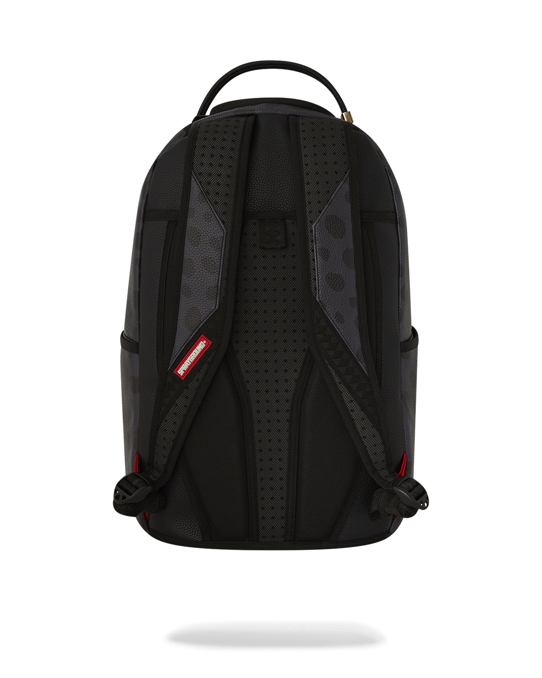 Close-up of the faux leather texture and Tyreek Hill collaboration badge on the Sprayground backpack.