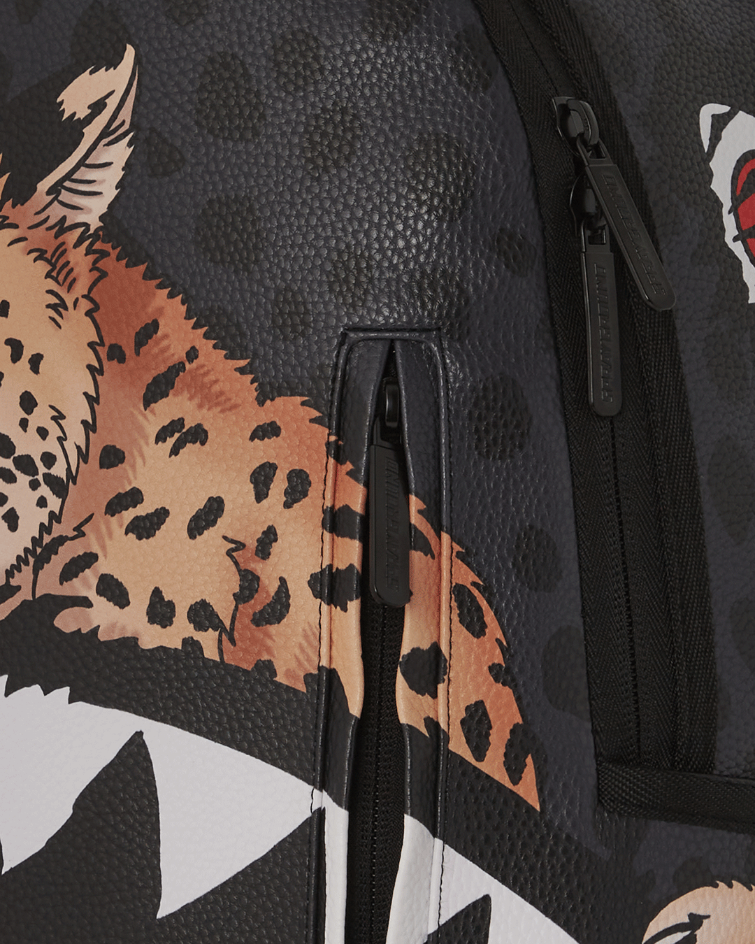 Close-up of the faux leather texture and Tyreek Hill collaboration badge on the Sprayground backpack.