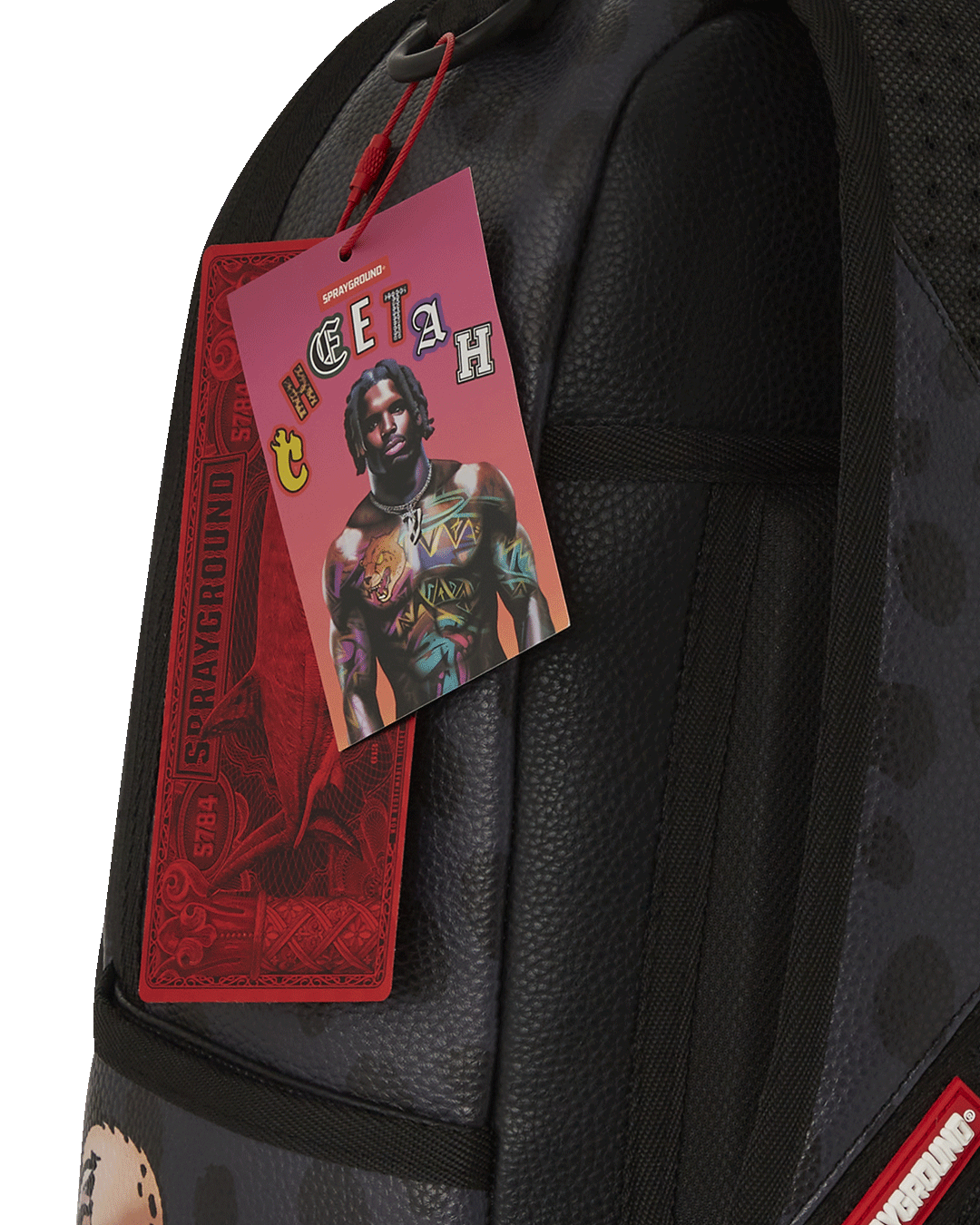 Close-up of the faux leather texture and Tyreek Hill collaboration badge on the Sprayground backpack.