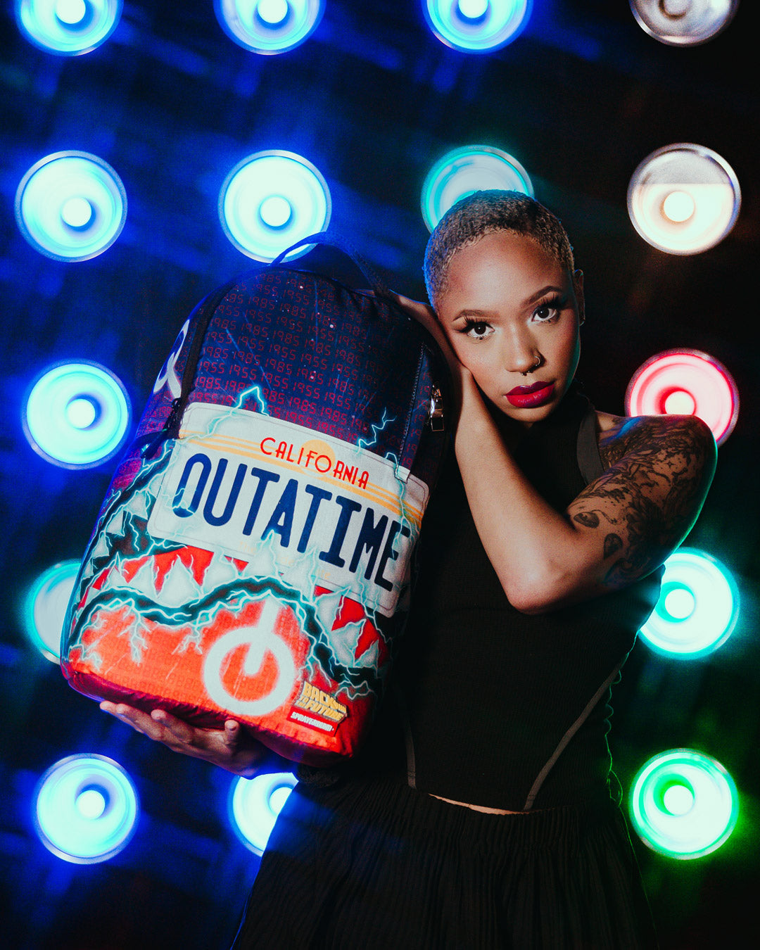 Side view of the OUTATIME Deluxe backpack featuring multiple pockets.