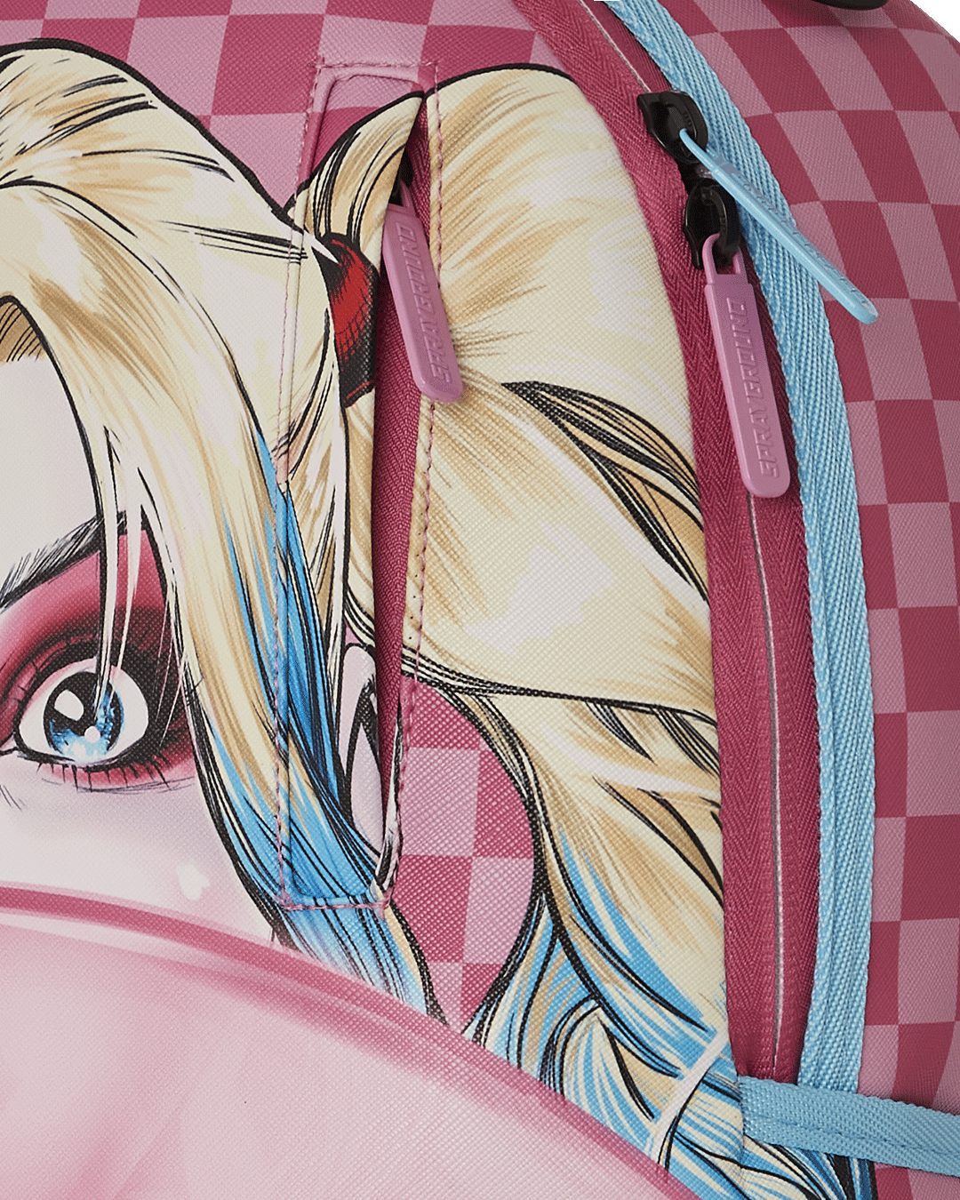 Detail shot of gold zippers and metal hardware on the backpack