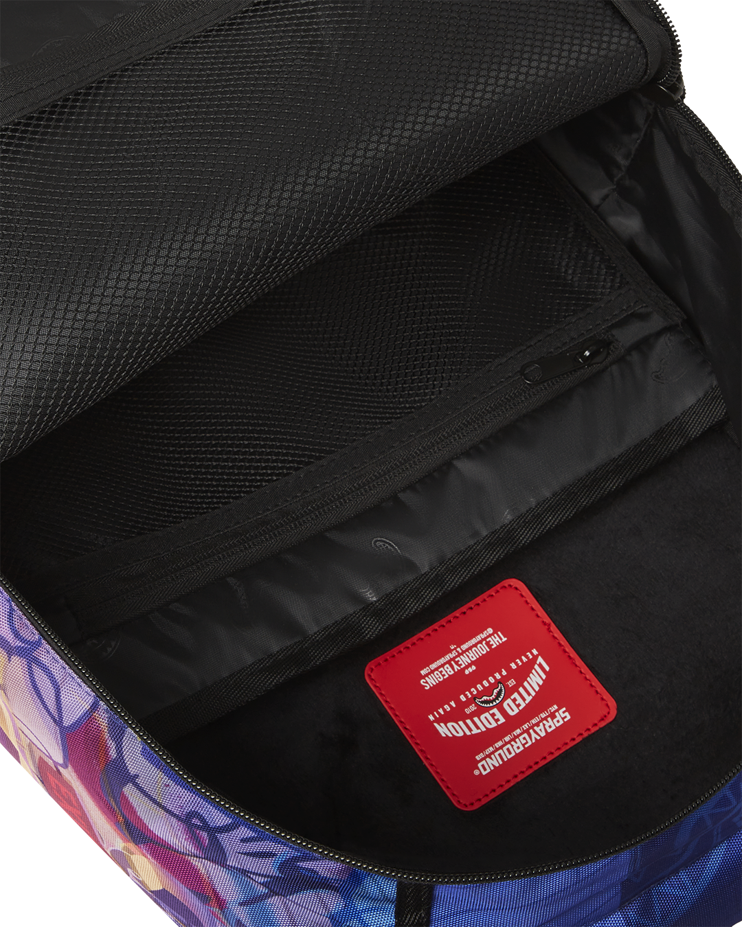 Close-up of the backpacks DC Comics graphics and zippered pockets