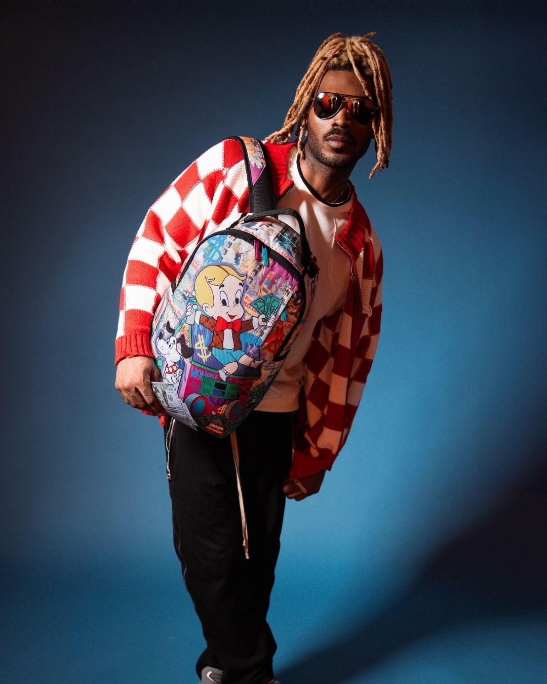 Interior view of Richie Rich Deluxe Sprayground Backpack with laptop compartment and mesh organizer.