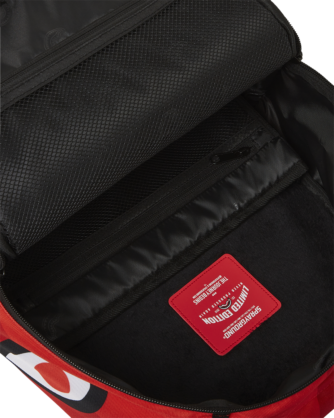 Close-up of the shark design and Sprayground Authentic badge on the backpack