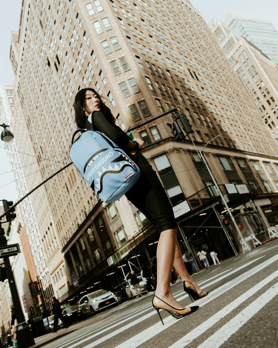 Backpack attached to rolling luggage via slide-through sleeve