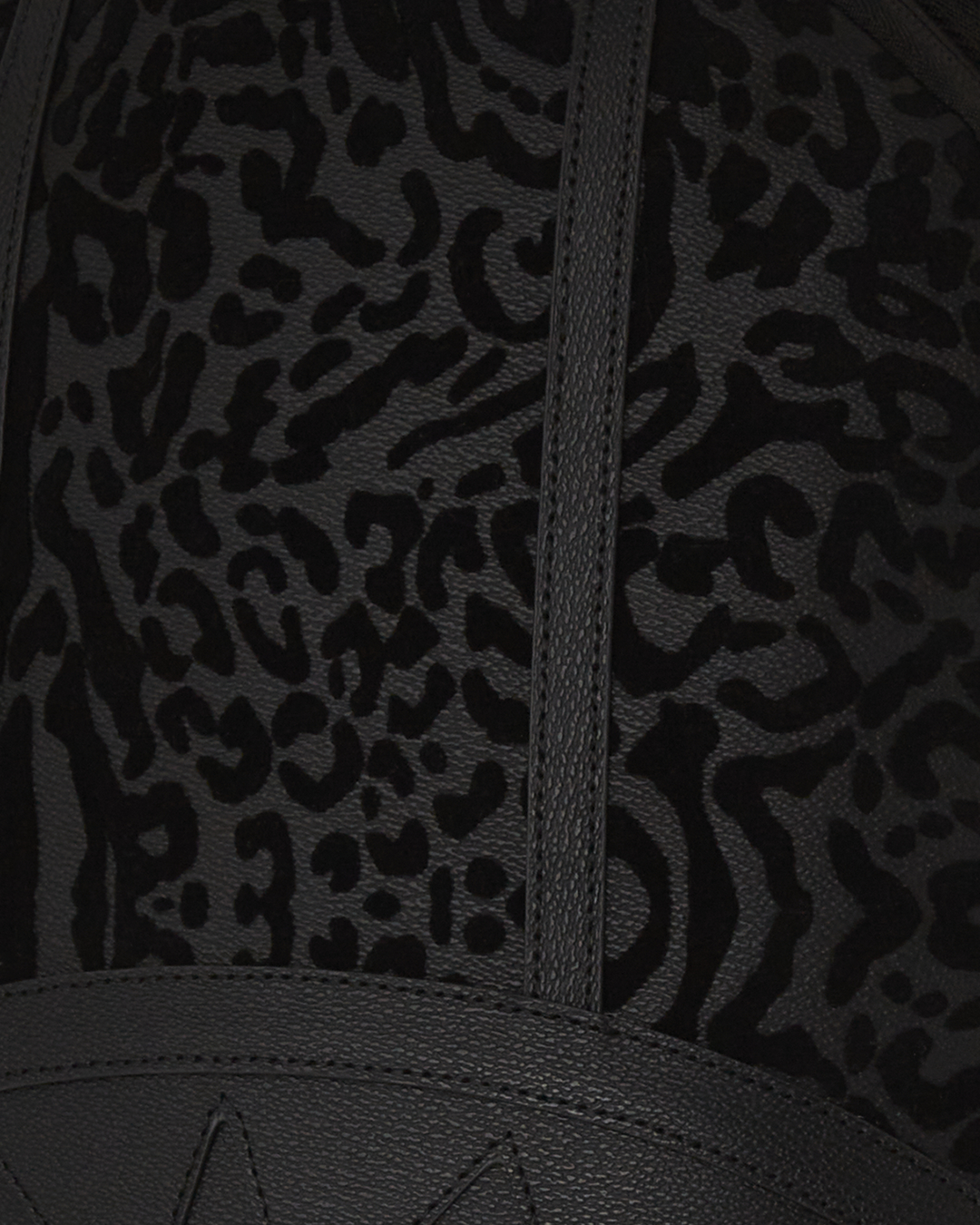 Front view of faux leather backpack with zippered compartments and urban styling