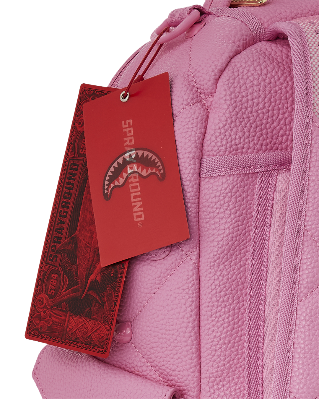 Front view of pink faux leather backpack with bear studs and quilted finish