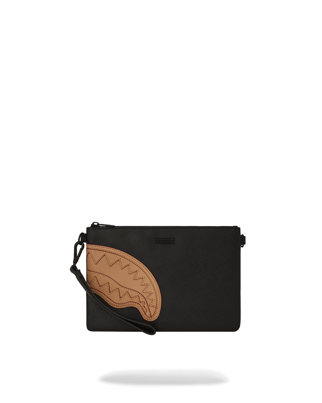 GRAND TOURER CROSSOVER CLUTCH being held as a handheld clutch, showcasing its gold accents.