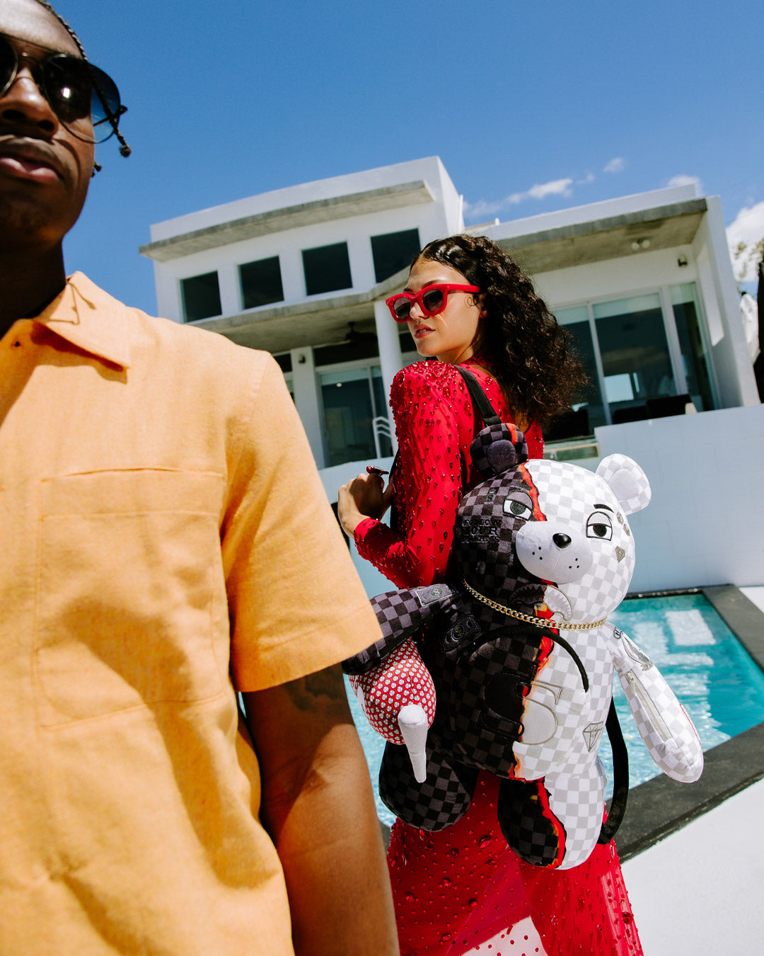 Front view of the Money Bear Teddy Backpack showcasing its zippered pockets.