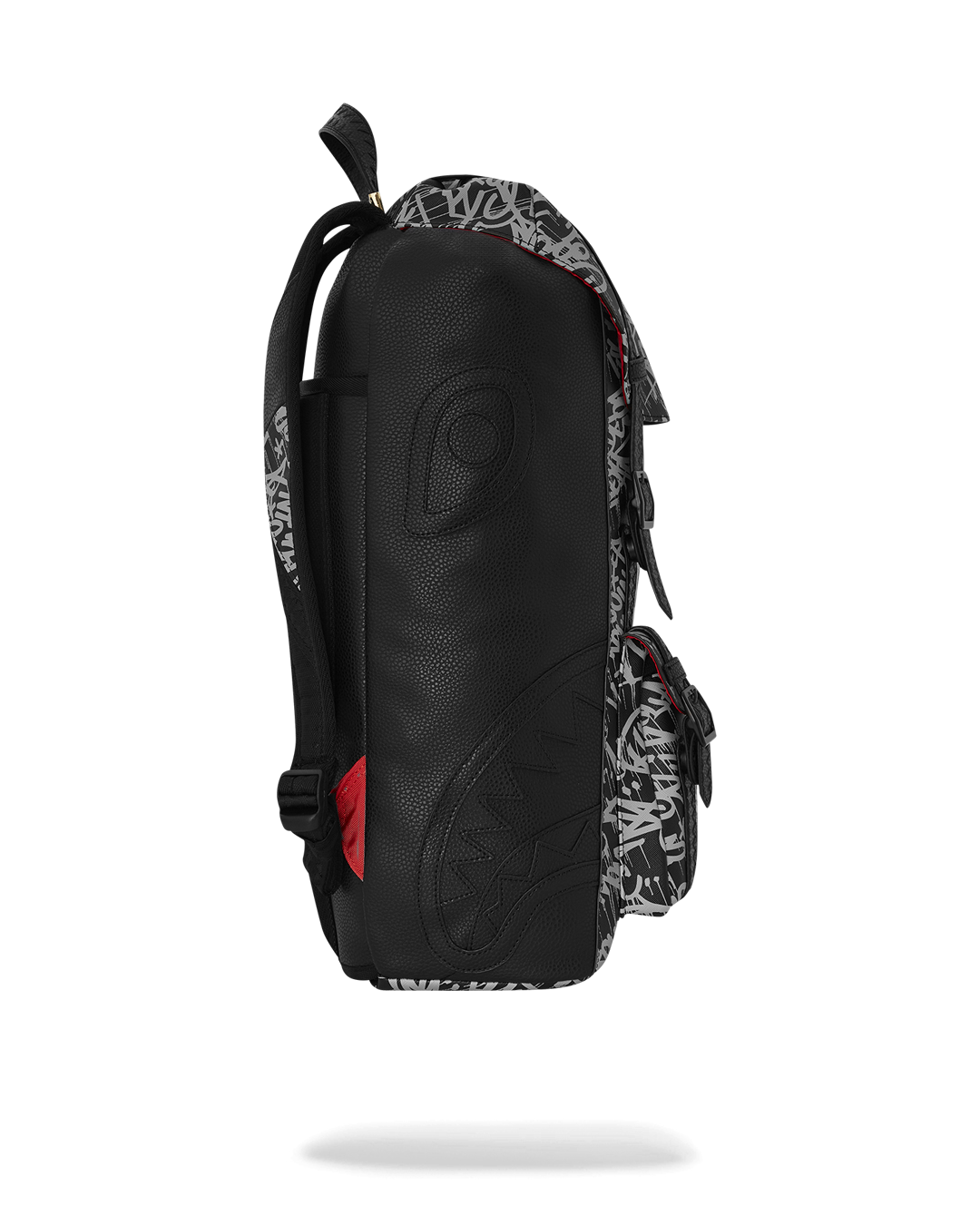 Close-up of the backpack’s magnetic snap buckle and embossed sharktooth straps