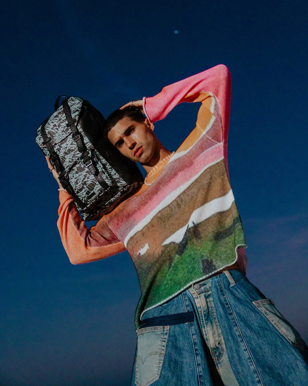 Backpack connected to carry-on luggage via slide-through sleeve