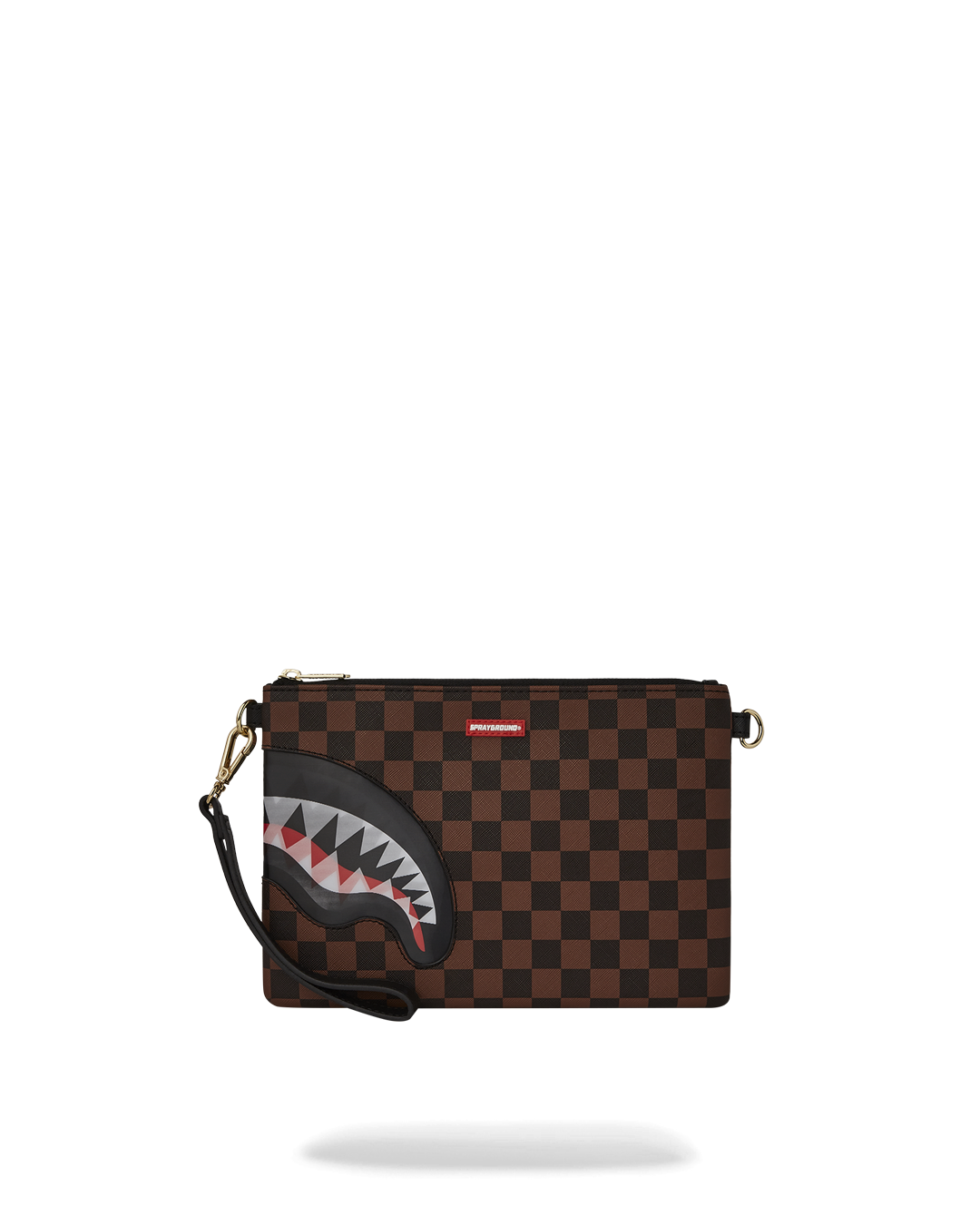Gold clutch purse with shark mouth design lying flat on marble surface