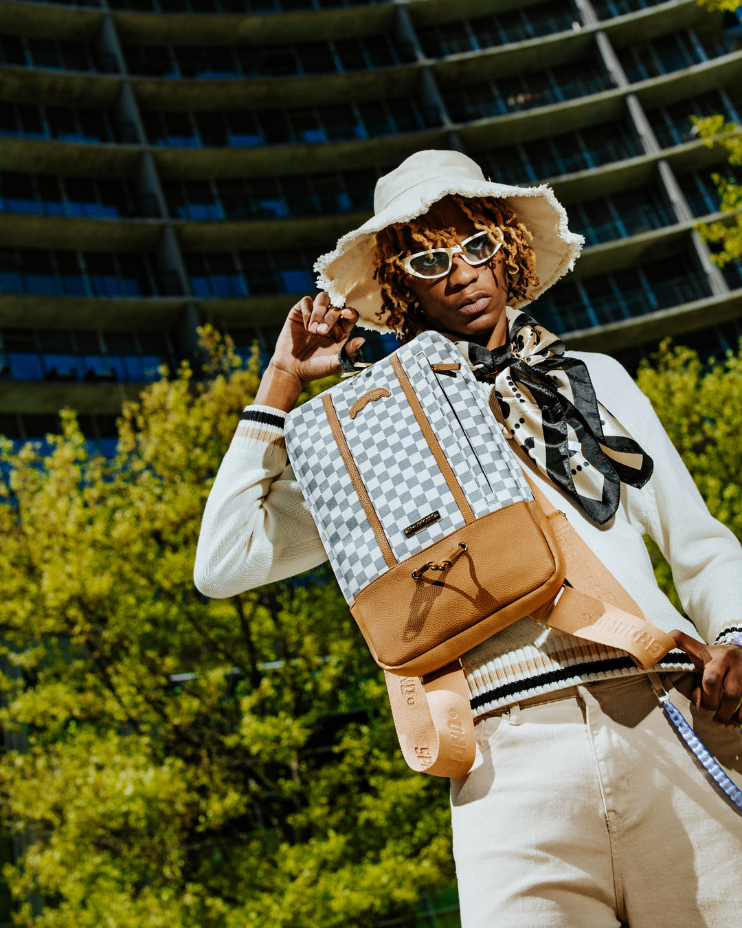 Henny Latte faux leather backpack with adjustable straps and ergonomic padding.