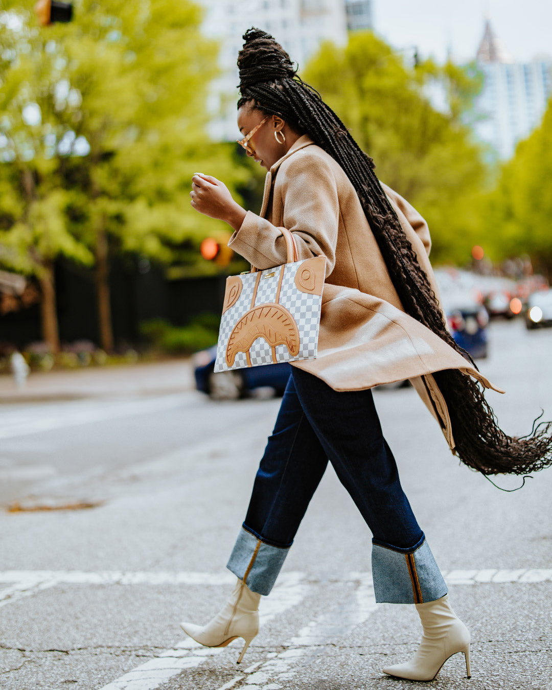 Henny Latte faux leather tote bag worn over the shoulder in a city setting