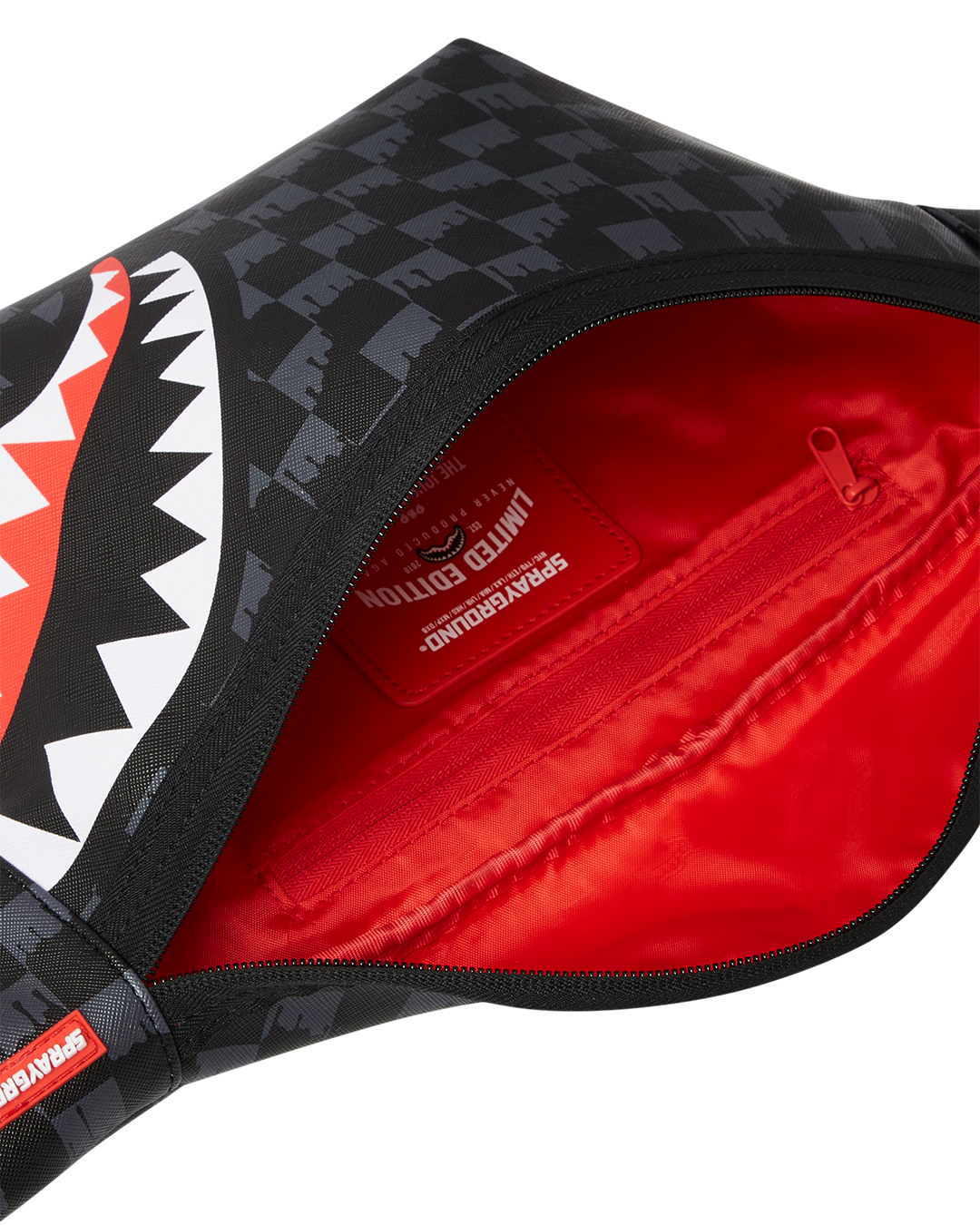 Vapor Shark leather crossbody bag displayed outdoors with essentials inside.