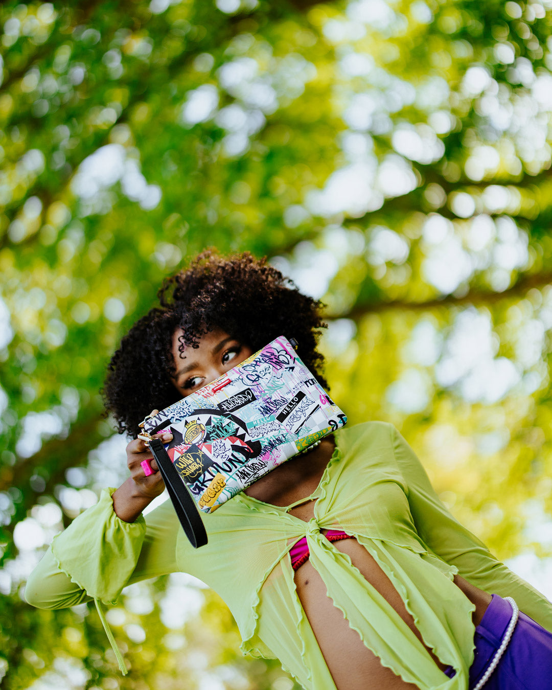 Convertible purse displayed as a clutch with wristlet strap