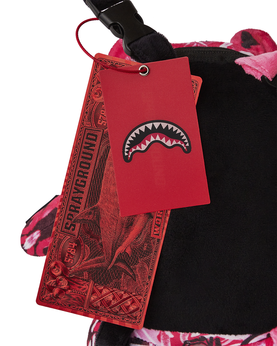 Close-up of the gold necklace detail on the mini backpack.