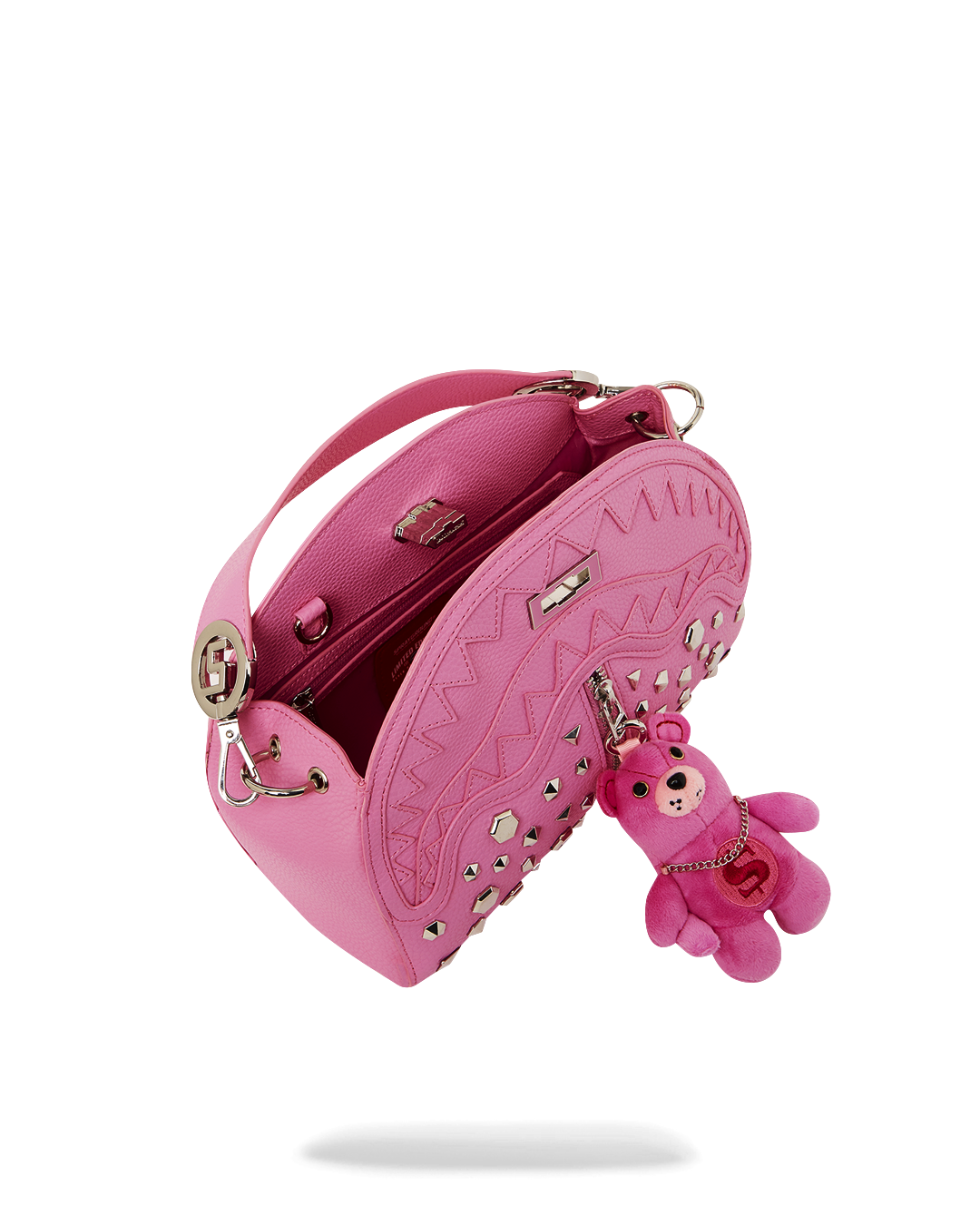 Luxury shark handbag with metal studs and silver turnlock, showcasing designer craftsmanship.
