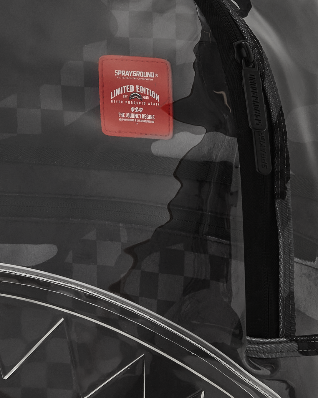 Close-up of the clear vinyl backpack showing its water-resistant exterior and pink accents