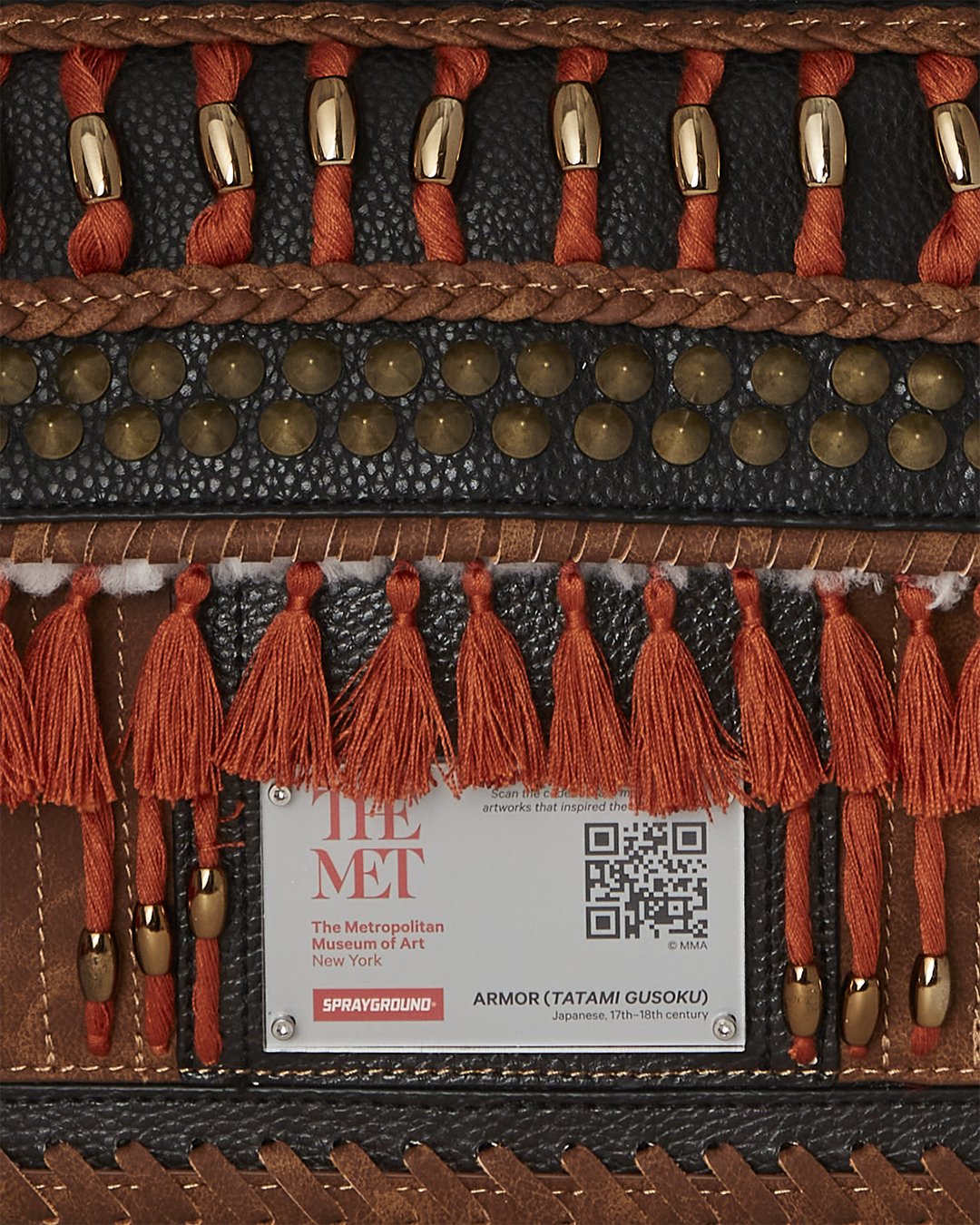 Front view of the faux leather rucksack backpack with gold studs and tassels