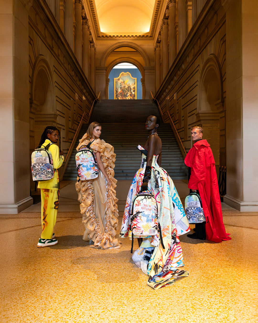 Front view of The Met Map Backpack, highlighting the graffiti design and gold zippers.