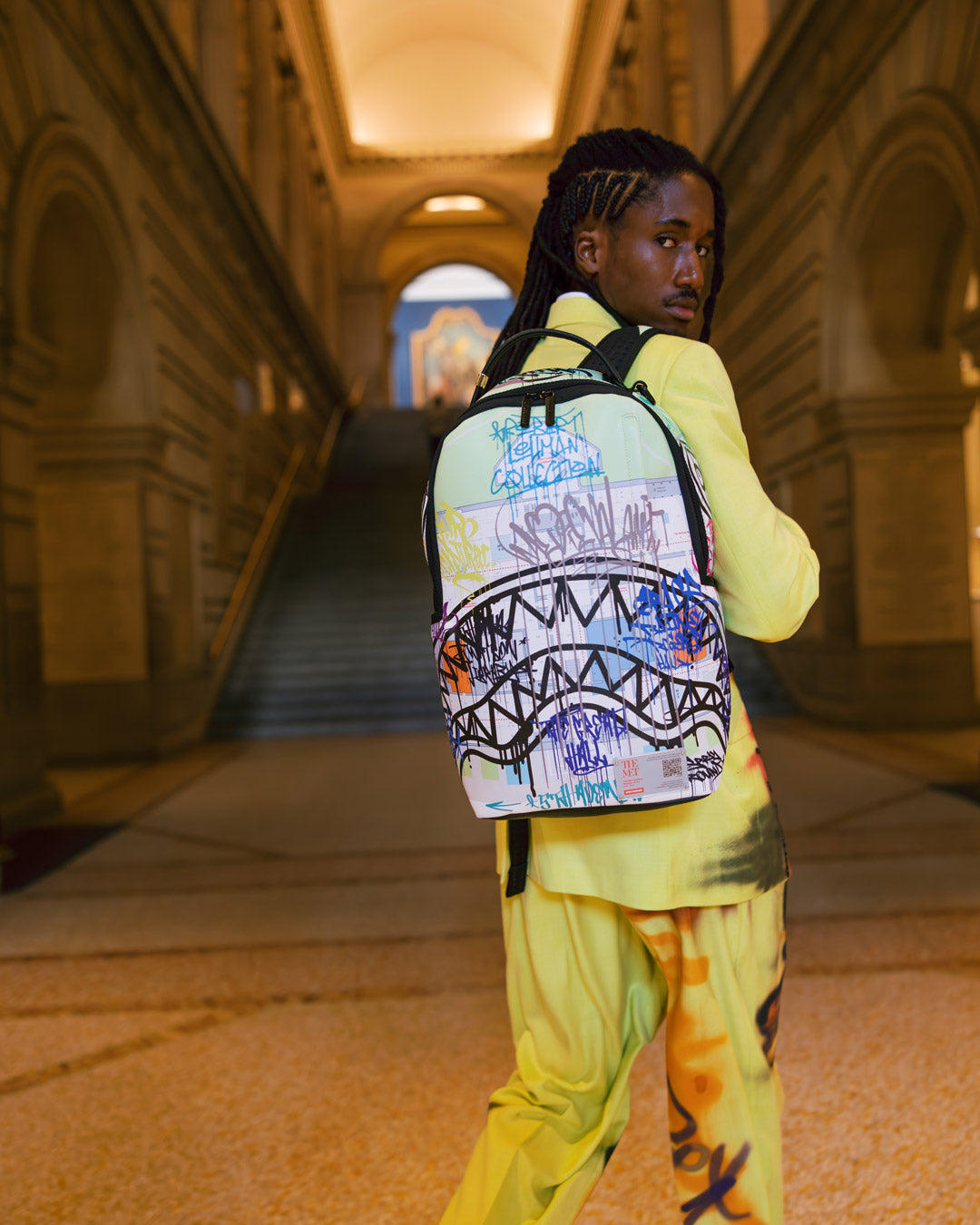 Side view of The Met Map Backpack showing adjustable straps and pockets.