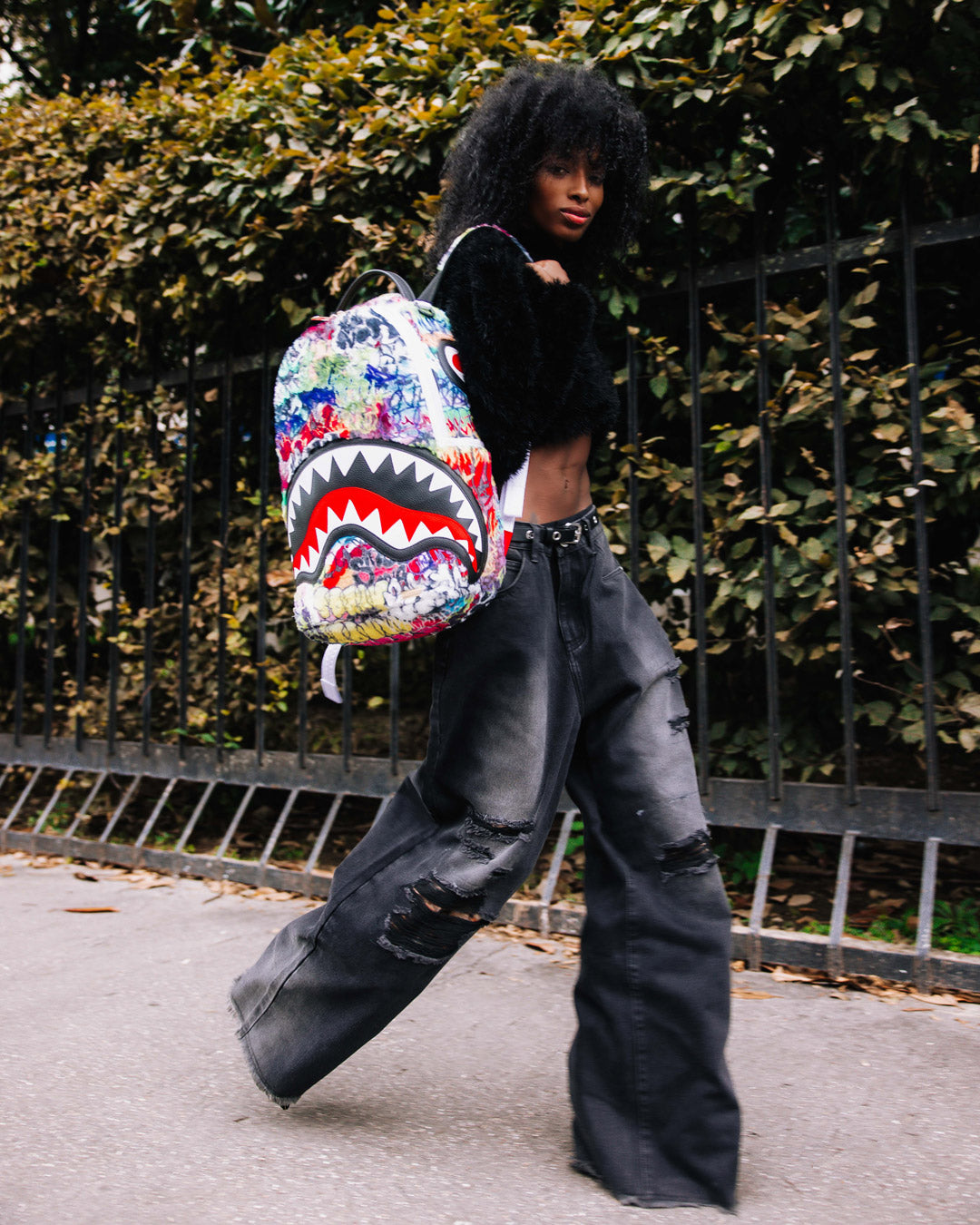 Side pocket of Graffiti Luxe Backpack for quick access to essentials.