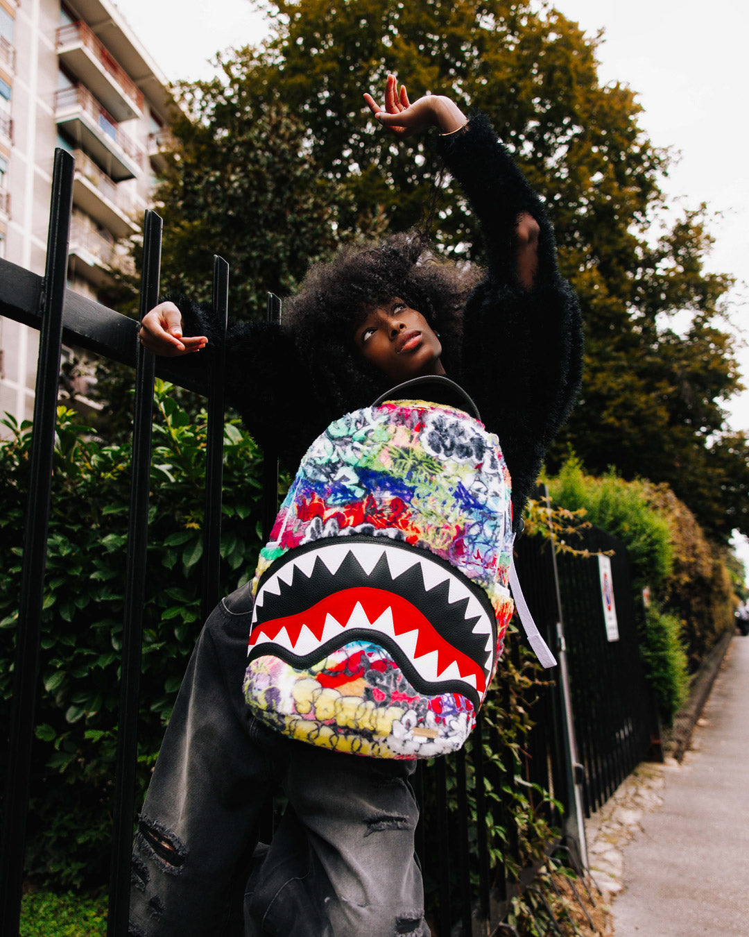 Front view of Graffiti Luxe Faux Leather Backpack showing graffiti design.