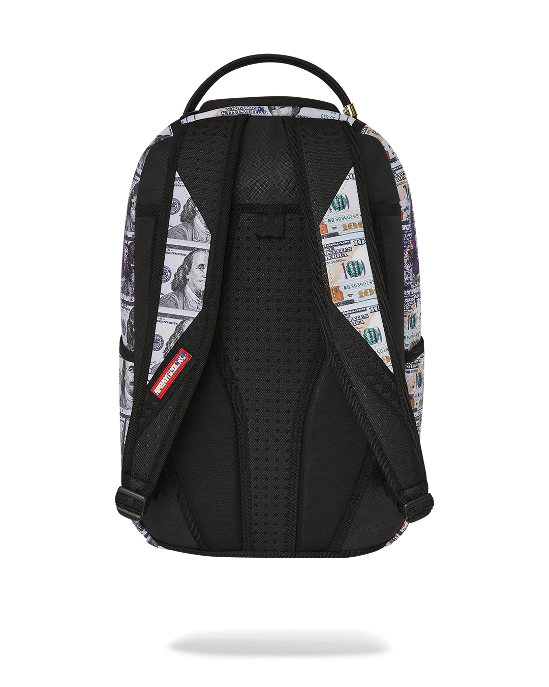 Close-up of the faux leather exterior with gold zippers and metal badge on the backpack