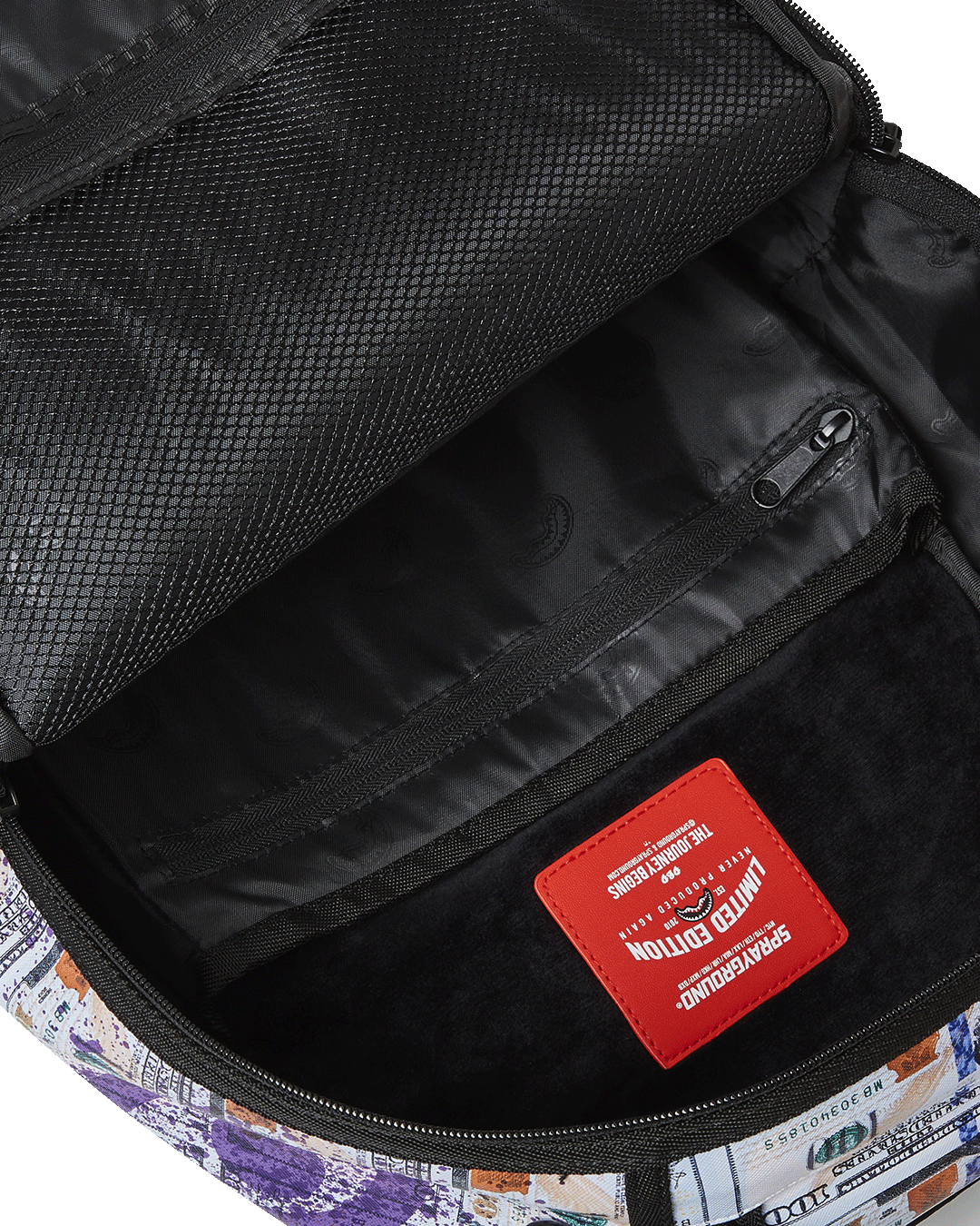 Interior shot showing the velour laptop compartment and organized mesh pocket