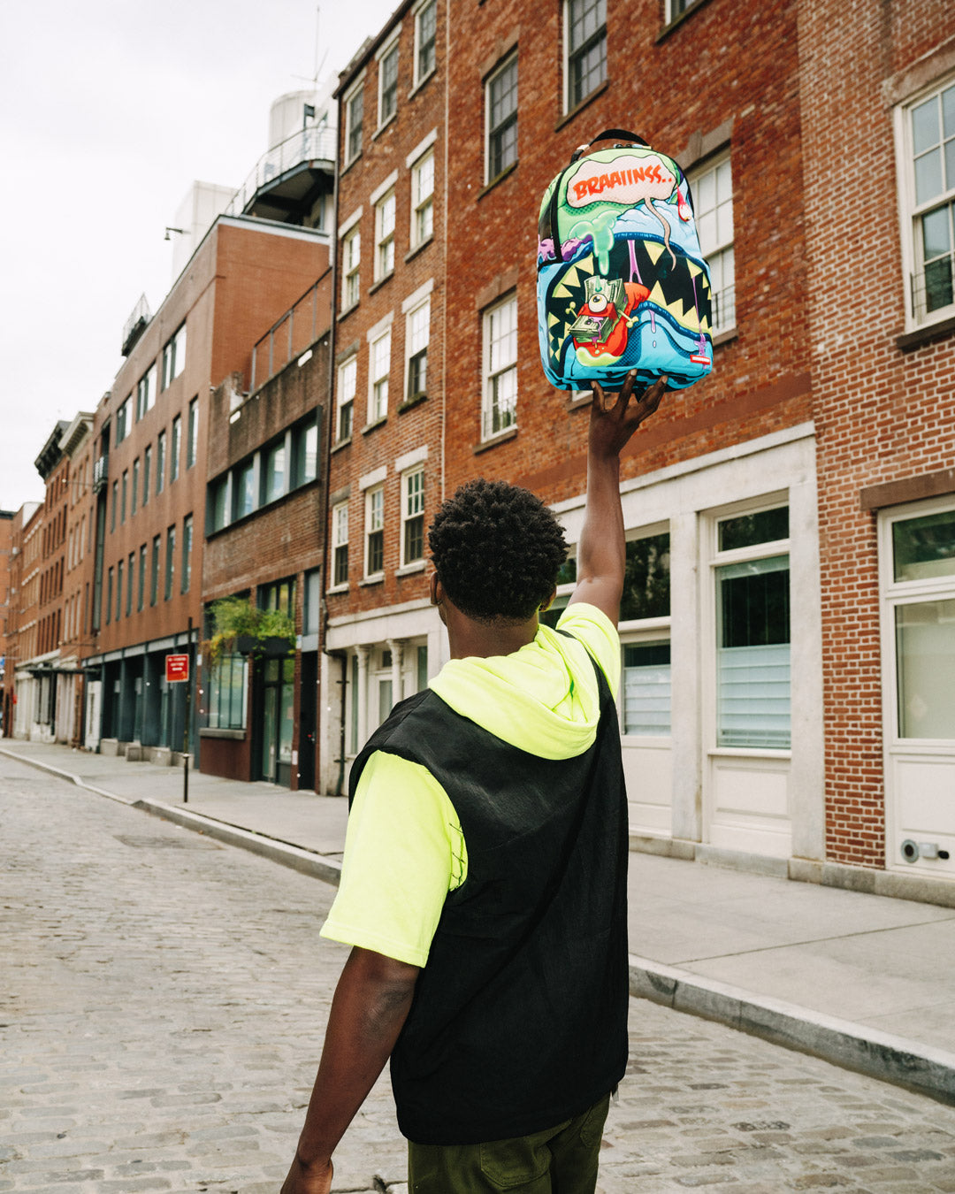 Backpack in use, showcasing ergonomic mesh back padding and adjustable straps.
