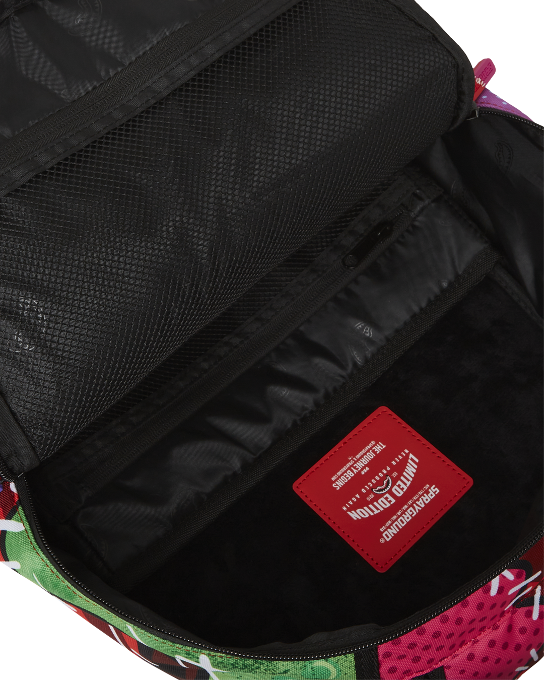 Close-up of the zombie sharkpocalypse backpacks front zipper pocket and gold hardware