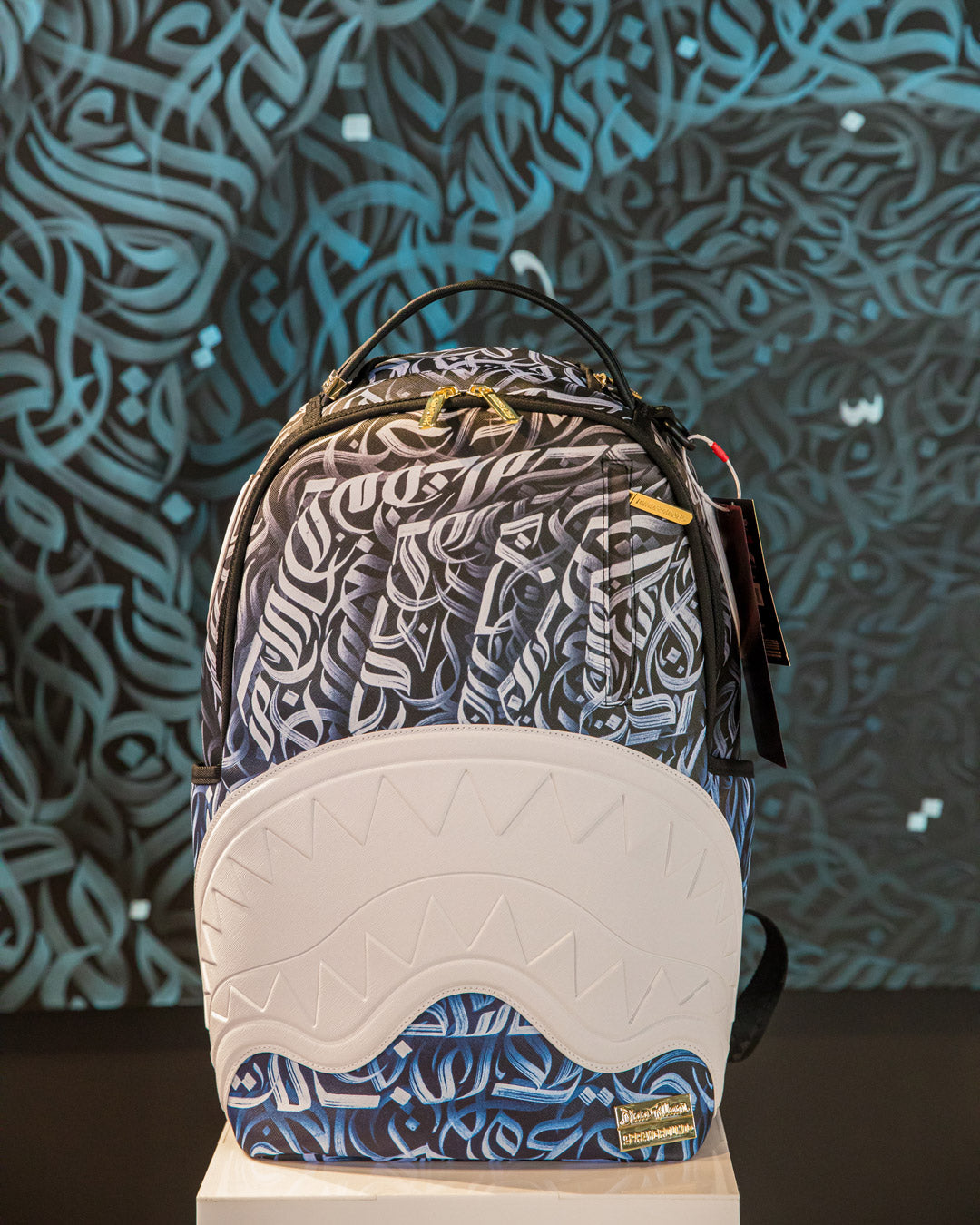 Side profile showing adjustable straps and side pockets of the Sprayground limited edition backpack