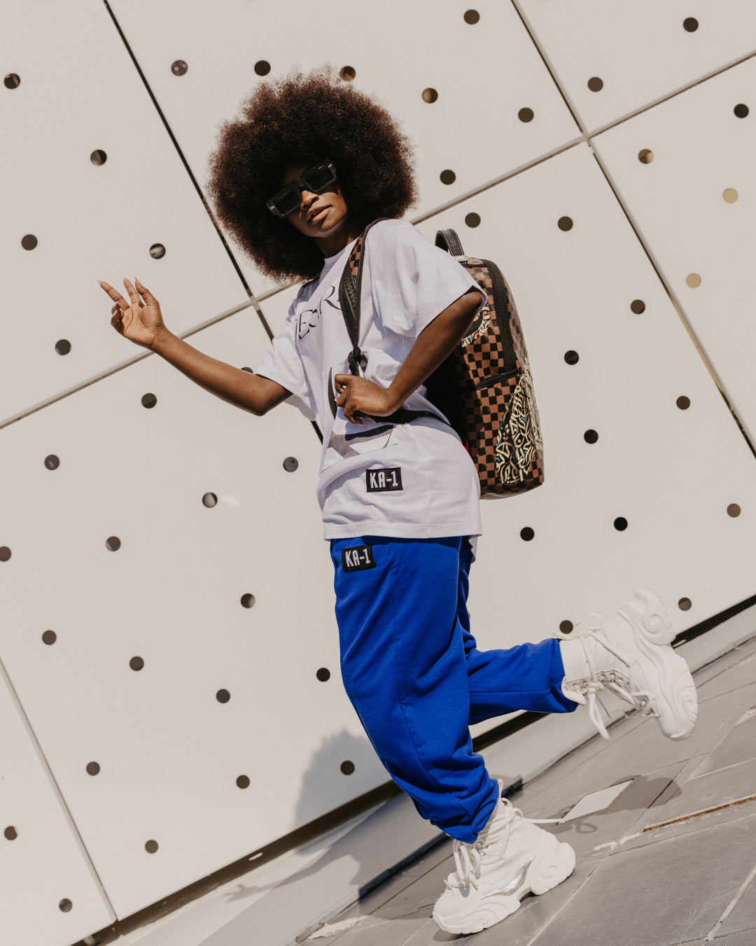 Diaa Allam Ehsan luxury backpack with faux leather exterior and gold zippers